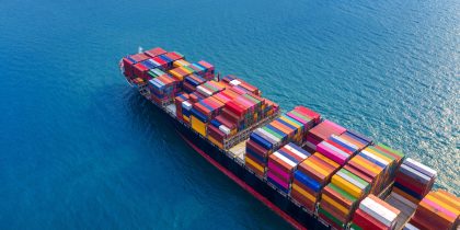 Aerial view of container cargo ship in sea.